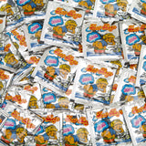 A stack of vibrant packets labeled "15 Fart Stink Bombs" looks like a playful prank toy. The packaging features cartoon characters and prominently displays the word "BOOM," enhancing its mischievous charm.
